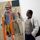Fab 5 Freddy with a work by Basquiat (Getty Images)